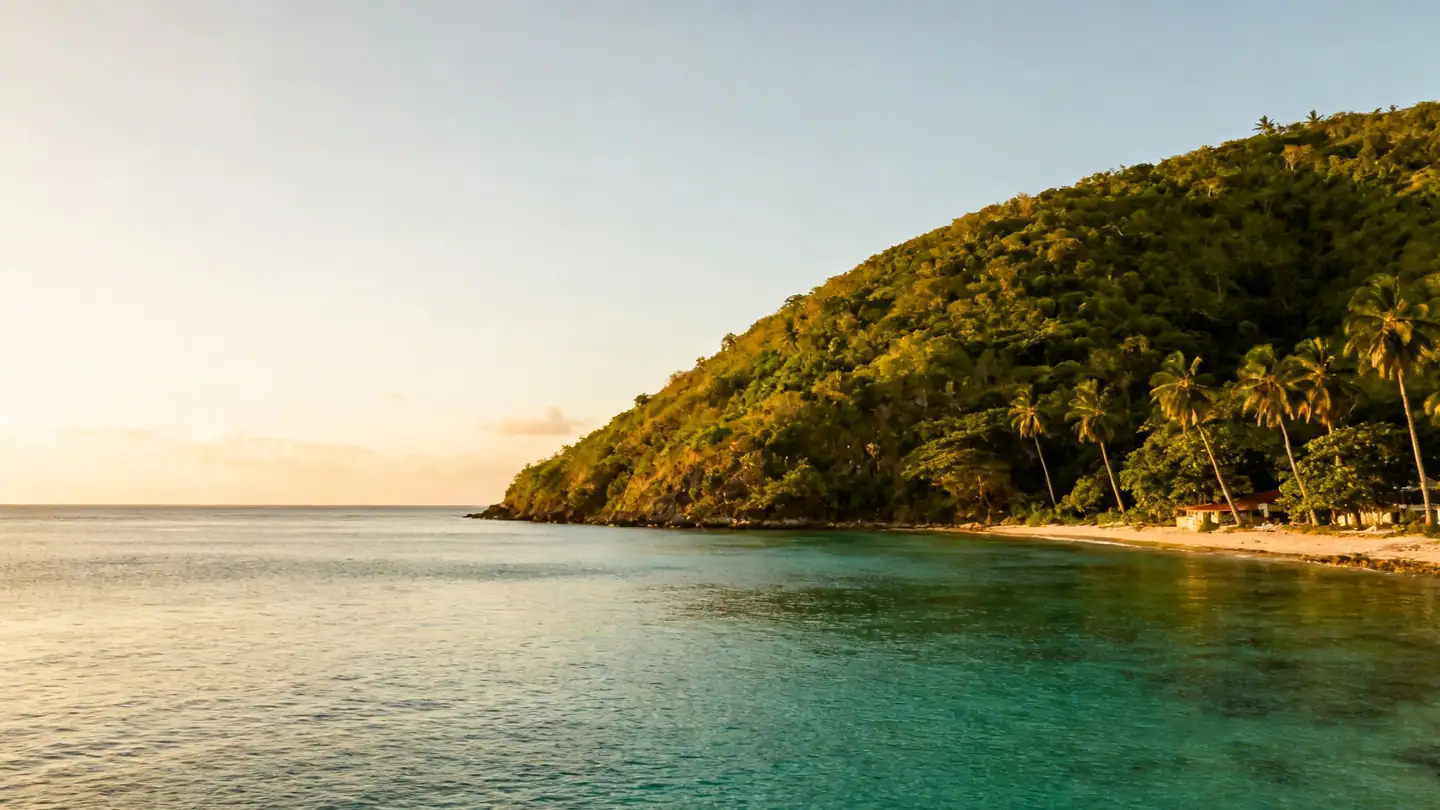 A calm Jamaican cove near Montego Bay: green hills in golden-hour light