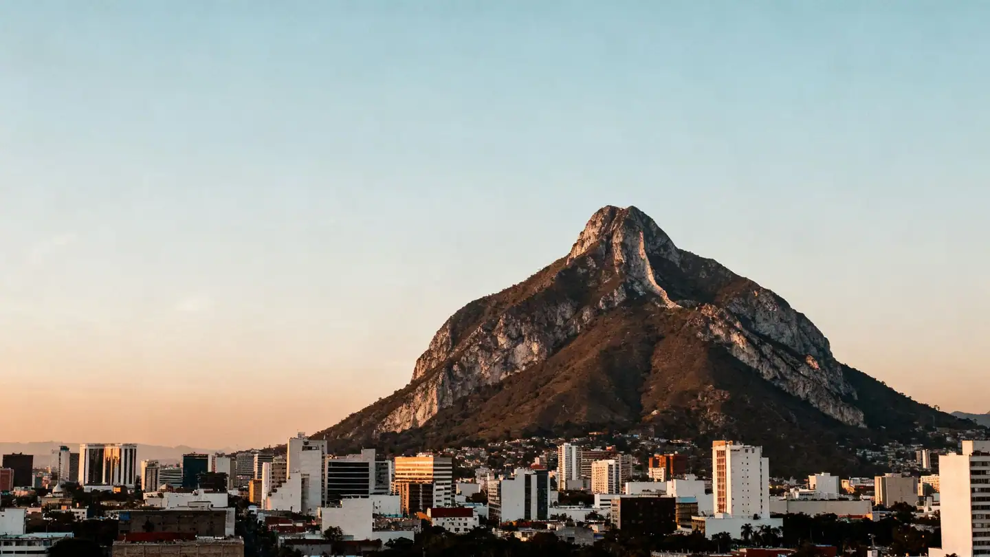 Monterrey: the saddle-shaped Cerro de la Silla mountain above the city skyline at sunset