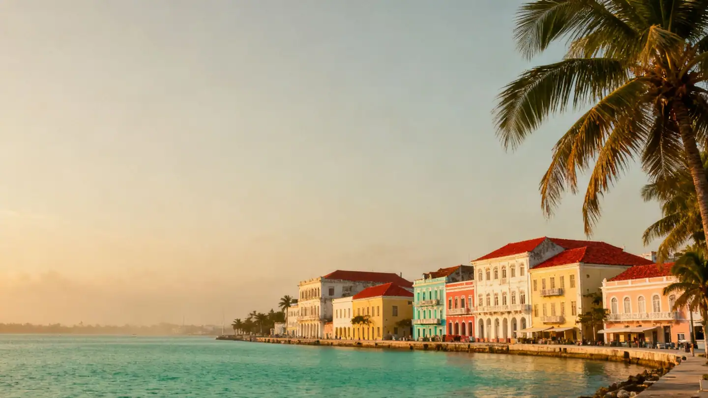 Nassau, Bahamas: a calm turquoise harbor with colorful colonial buildings and palm trees in golden-hour light
