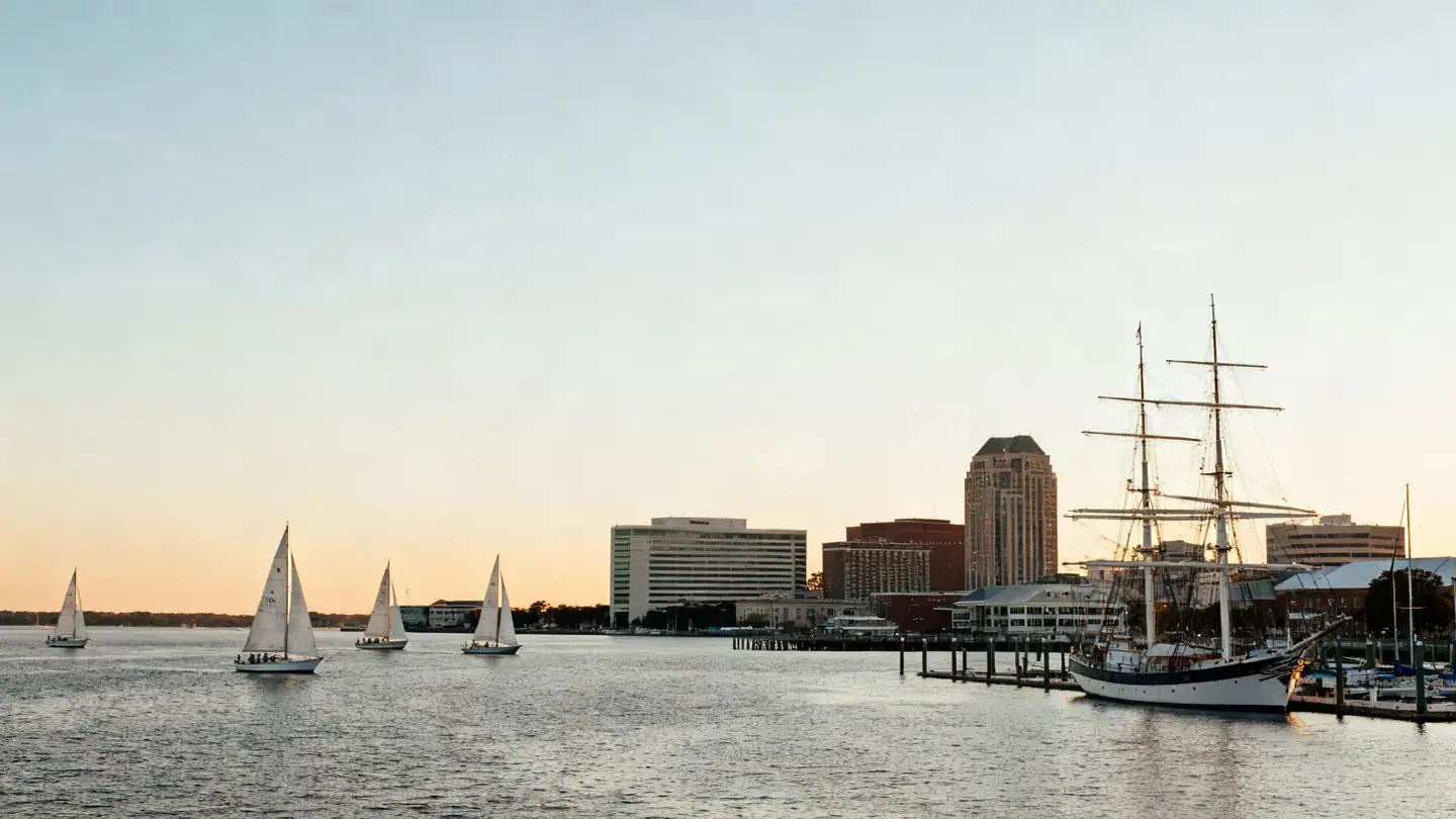 Norfolk, Virginia: a harbor waterfront on the Elizabeth River with sailboats at sunset