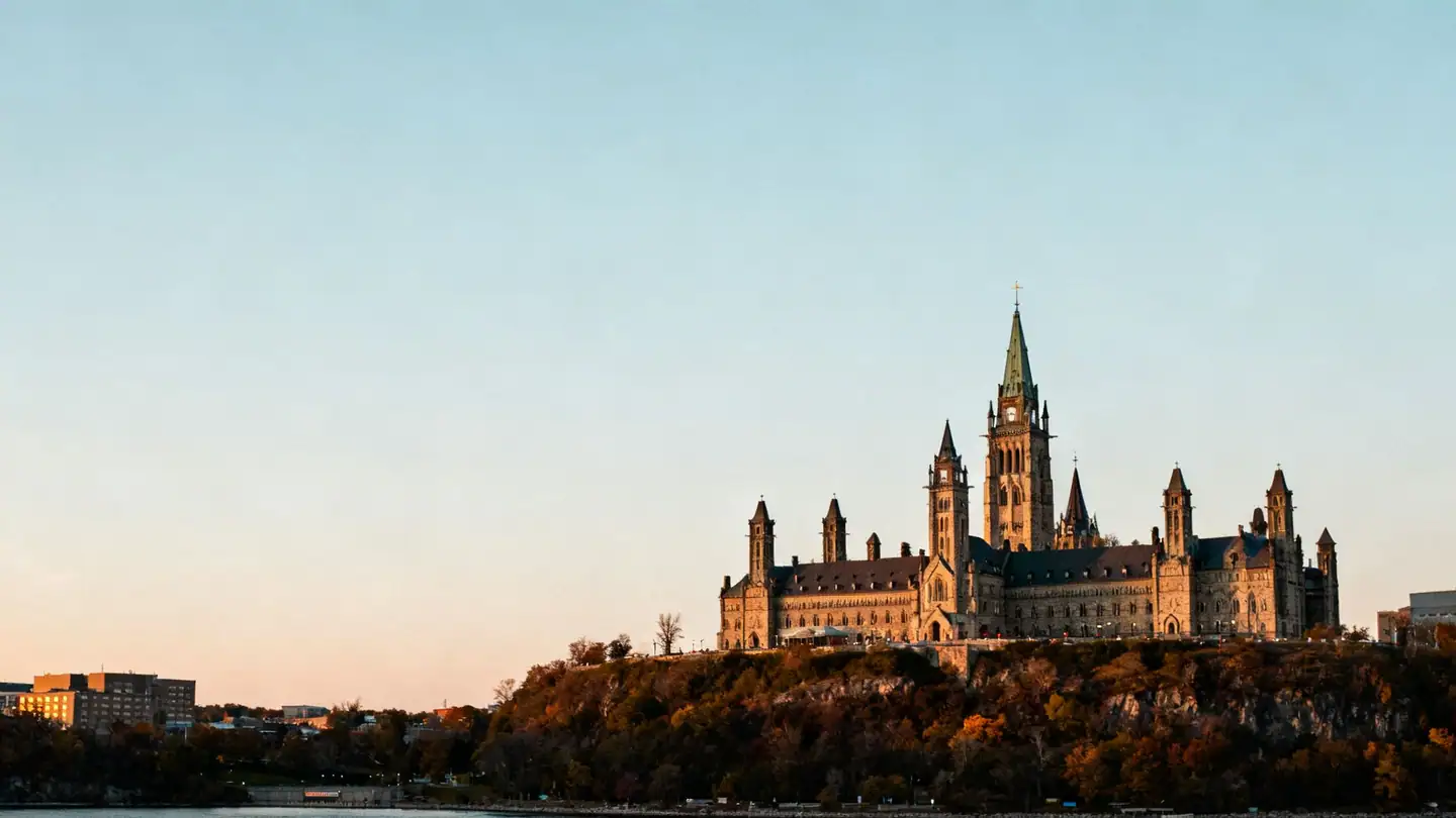 Ottawa: a Gothic Revival parliament building on a bluff above the river at sunset