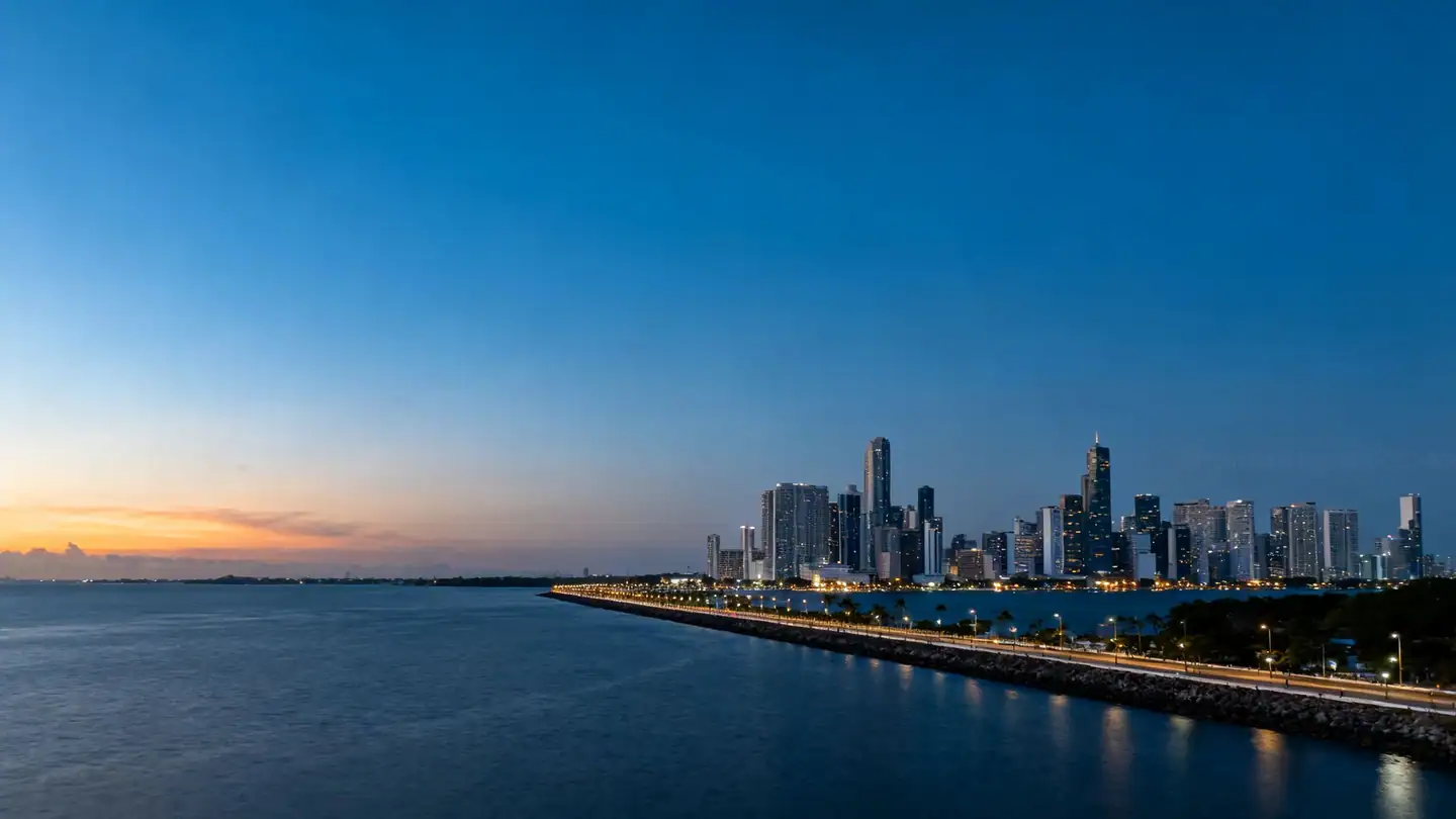 The Panama City skyline across the bay with a long coastal promenade at dusk