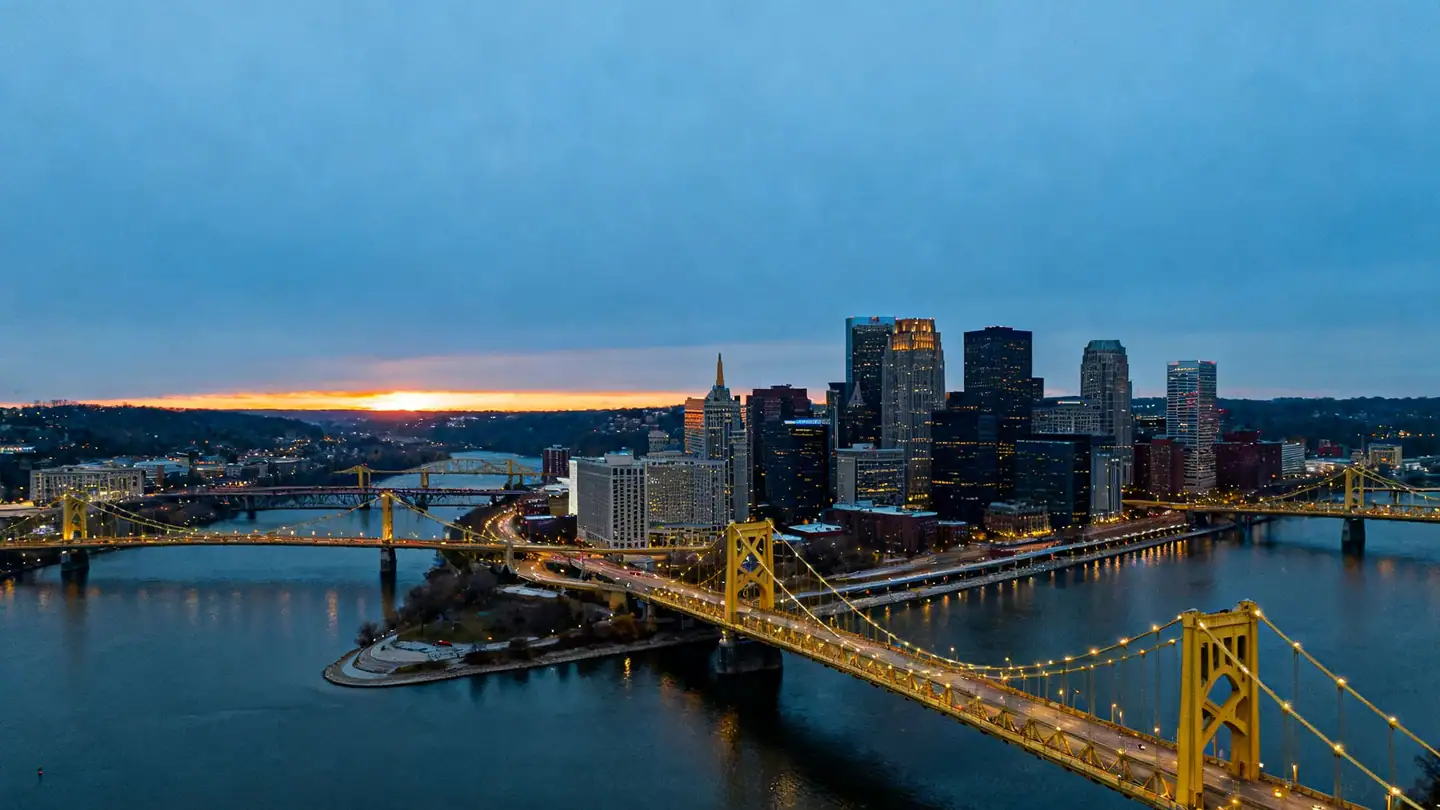 Pittsburgh's skyline at the point where three rivers meet at dusk