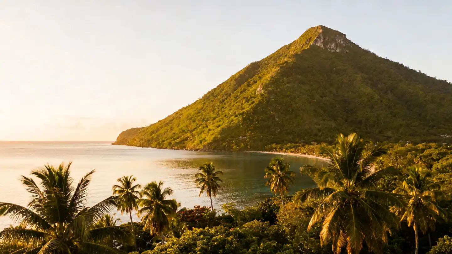 Puerto Plata: a green mountain above a Caribbean bay with palms in golden-hour light