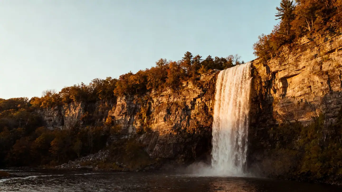 Rochester, New York: a high waterfall in a gorge in the middle of the city in golden-hour light