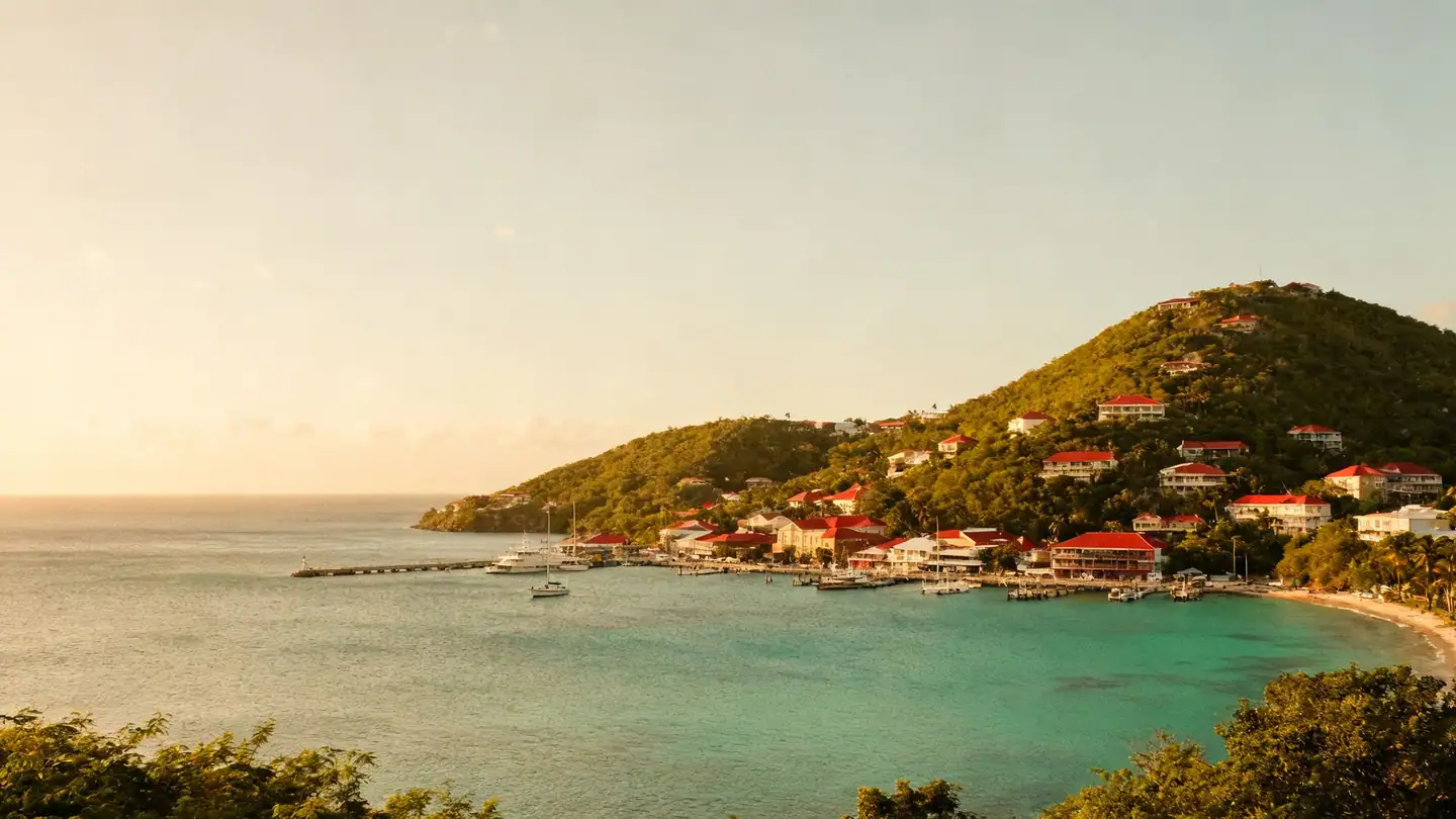 St. Thomas, U.S. Virgin Islands: a harbor town with red roofs on green hills above a turquoise bay in golden-hour light